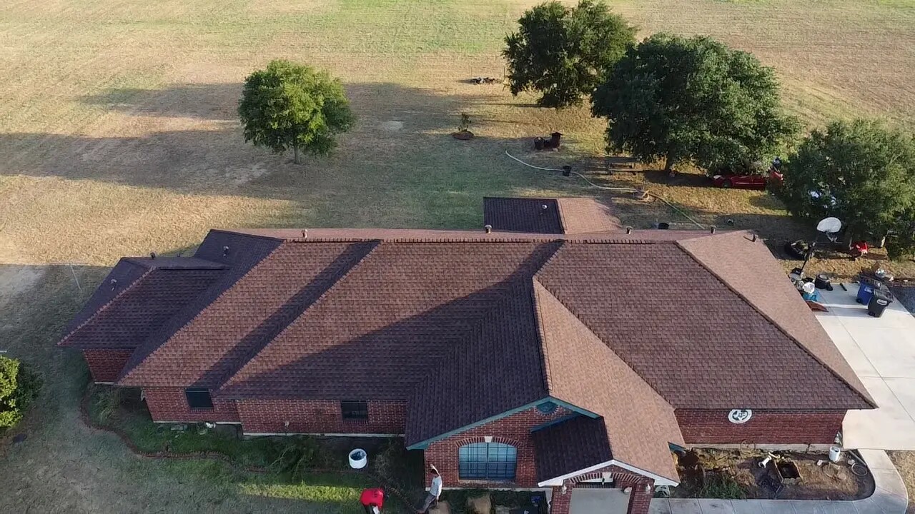Aerial view of a completed brown shingle roof