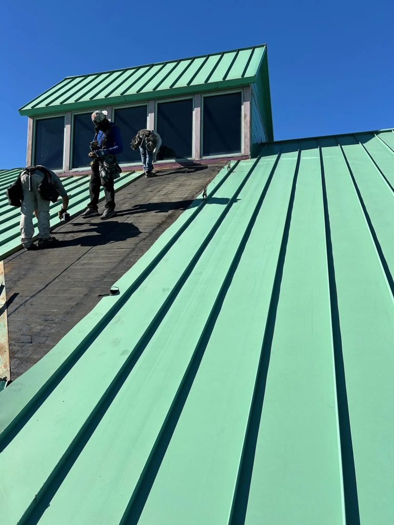 Crew installing a metal roof