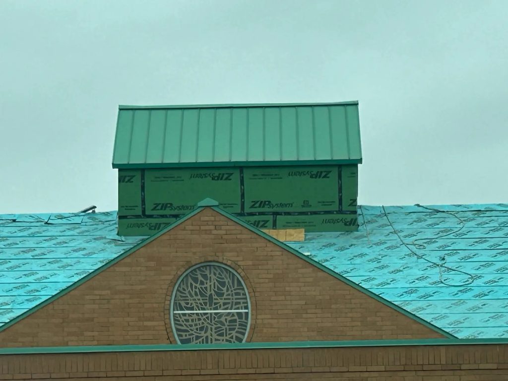 Church roof with roofing work in progress