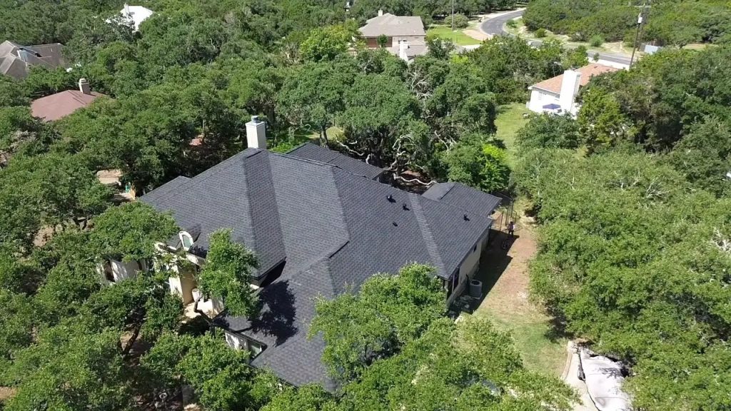 Aerial view of a completed multi-slope shingle roof