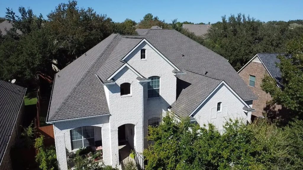 Home with a completed gray asphalt shingle roof