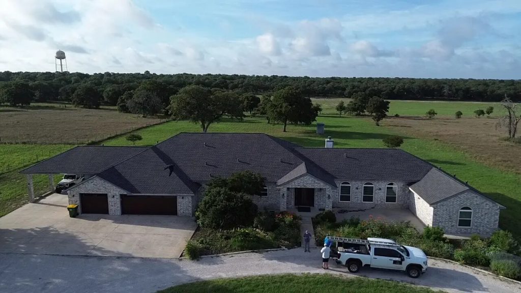 Shingle roof with crew and work truck